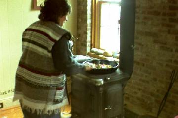 Carol cooking at the woodstove